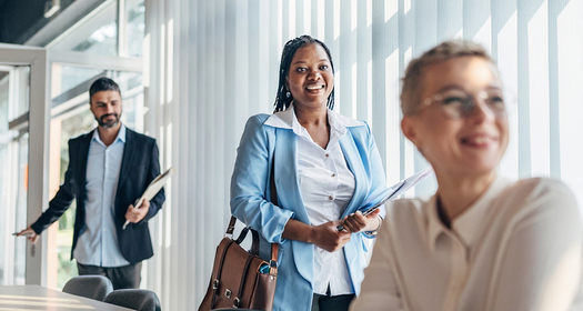 Three business people in a modern and bright meeting room
