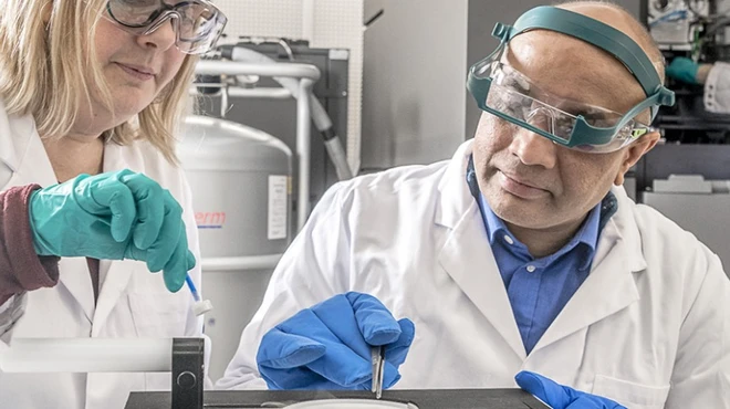 Scientists prepare a sample for imaging by a cryo-electron microscope.