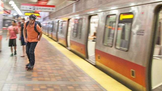 Tyler Patron rollerblades to work.