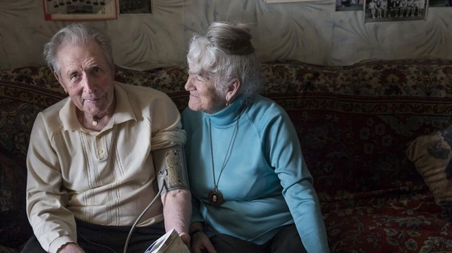 Tamara Yachmentseva and her husband sitting on a couch