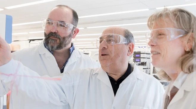 Novartis scientists work side-by-side with a scholar