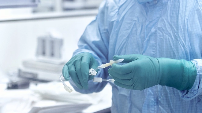 A process operator prepares connecting hose for later use in production process