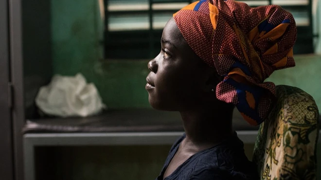 A young girl sits at a health clinic in Sikasso, Mali.