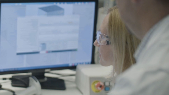 Scientists looking at data on screens