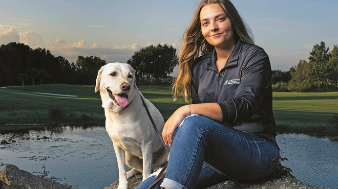 Novartis Annual Report 2024 cover: Kate Kostelyk, IgA nephropathy (IgAN) patient, and her labrador Dakoda in Mims, Florida