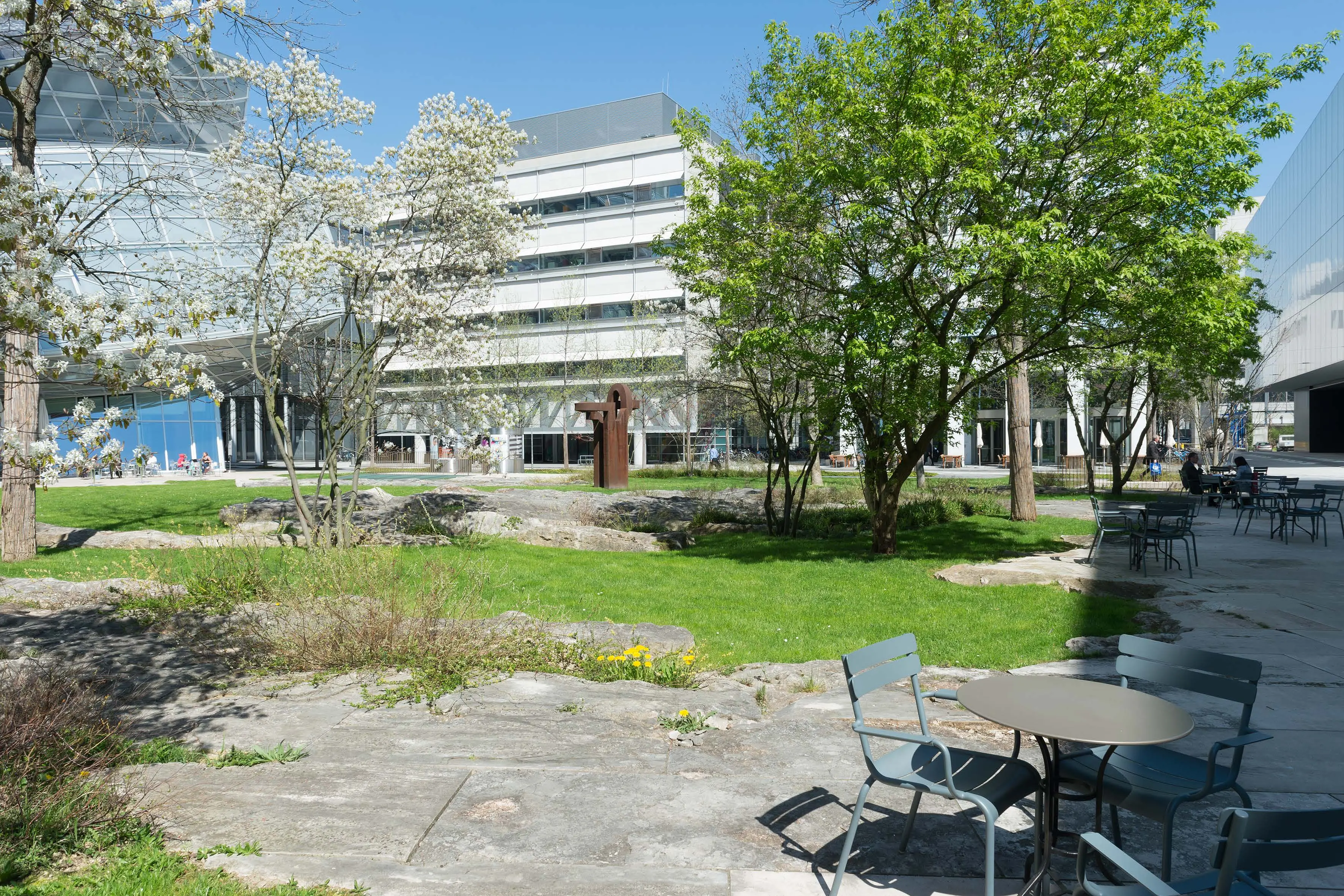Tables and chairs next to green space