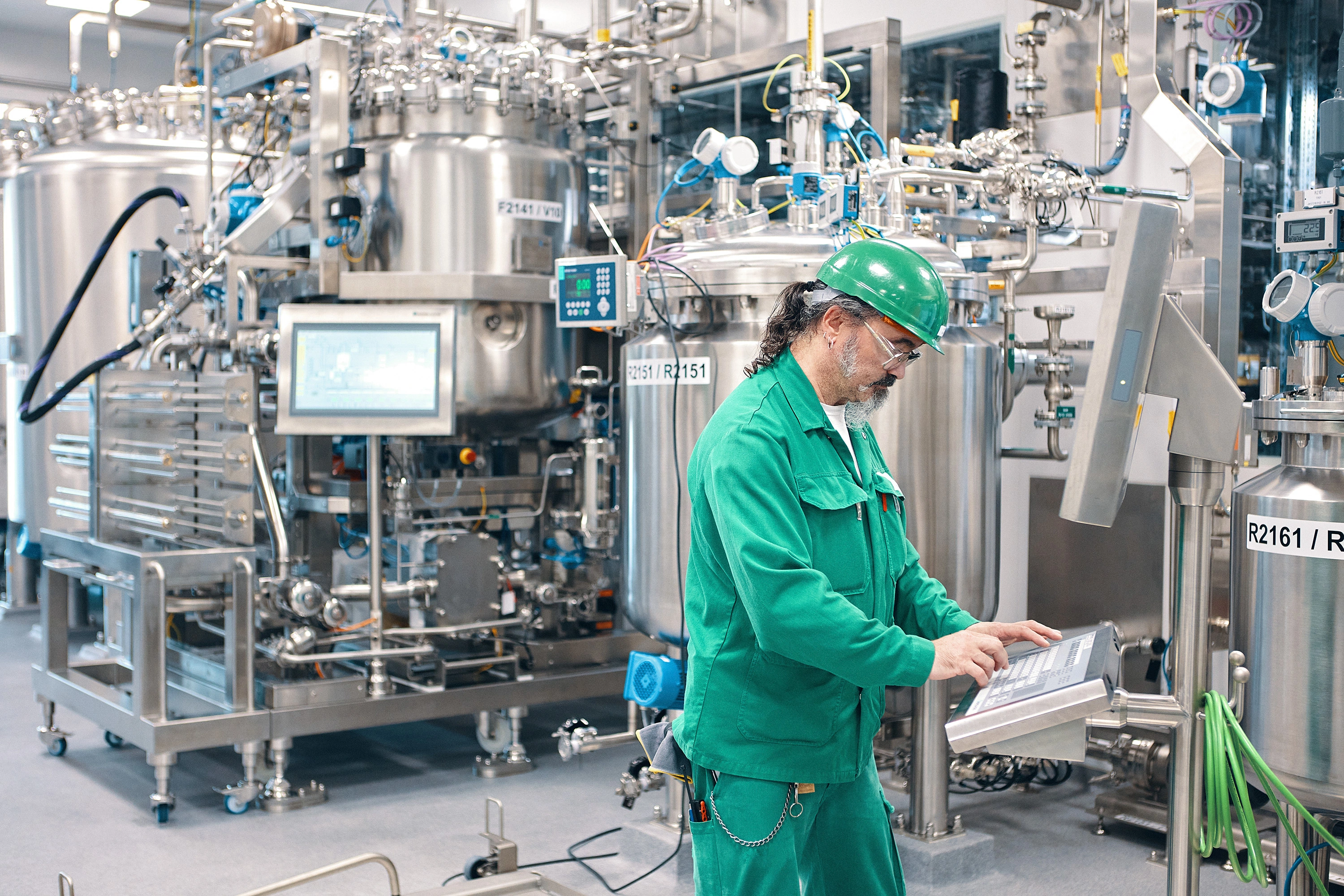 Production specialist on a computer working on RNA production in Schweizerhalle, Switzerland