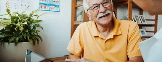 hcp-discussing-with-smilling-senior-patient-card