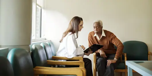 A cardio-metabolic heart patient talking with a healthcare professional