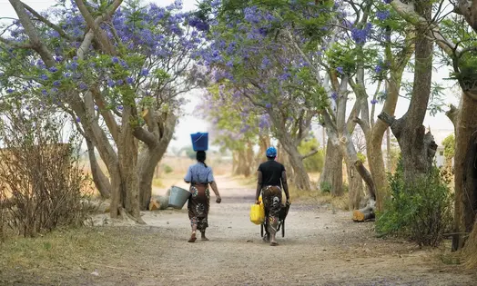 Two women carrying water