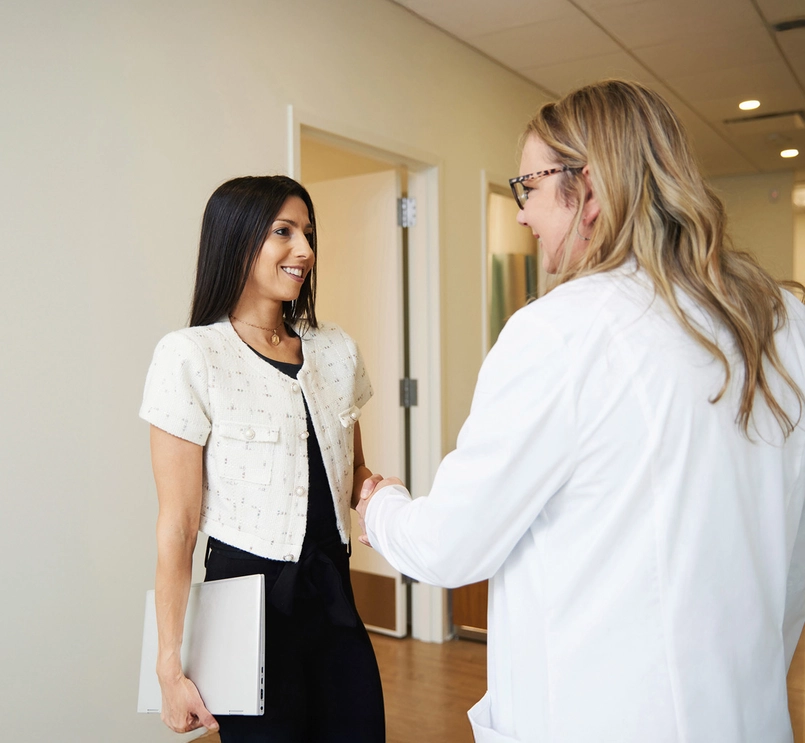 Business person and doctor shake hands