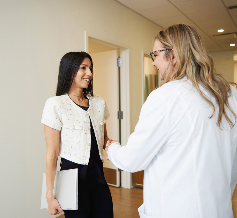 Business person and doctor shake hands