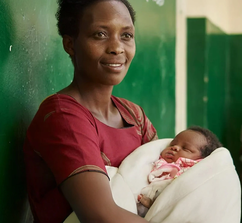 mother waiting with infant in clinic Africa