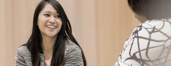 Woman smiling and talking with a colleague