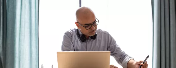 Man working at table on laptop