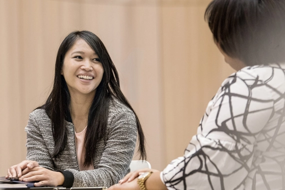 Woman smiling and talking with a colleague