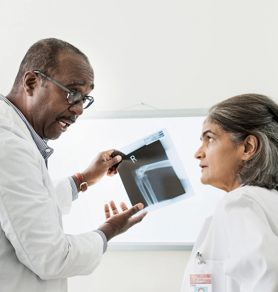 two doctors examining x-ray