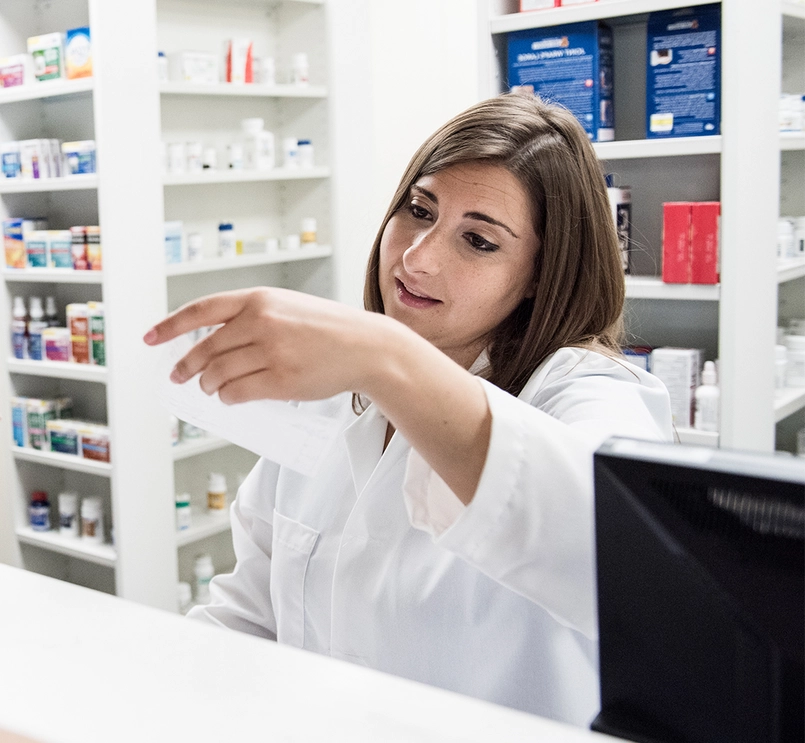 Pharmacist reading customer's prescription
