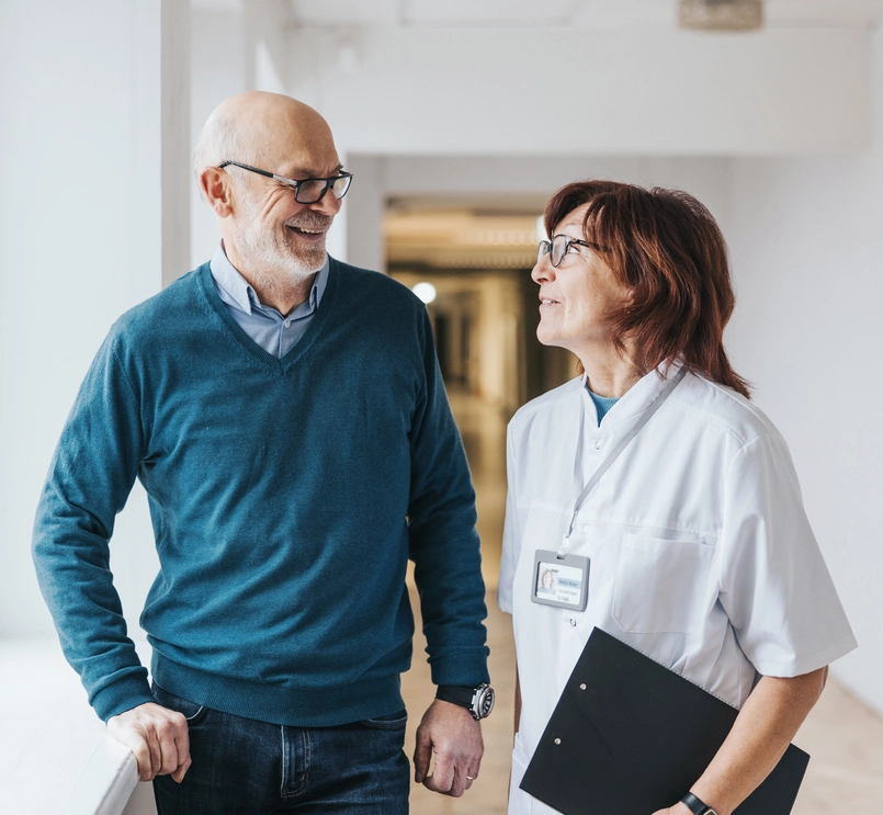 doctor-and-patient-talking-hallway