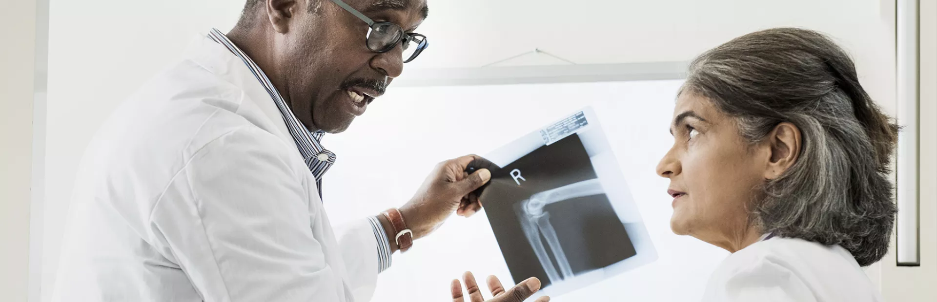 Two doctors examining X-ray