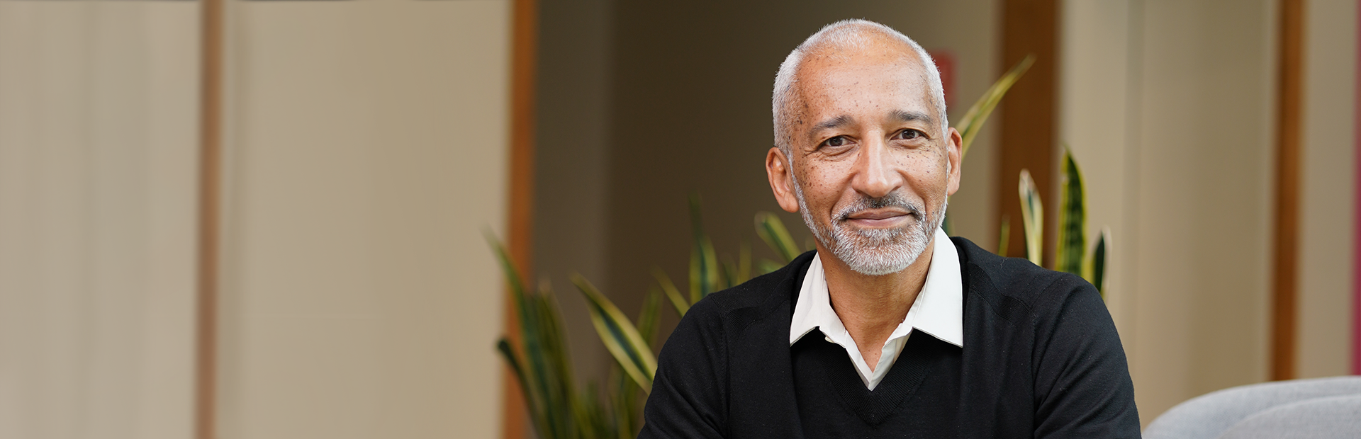 Portrait of Thierry Diagana, California Site Head for Novartis Biomedical Research, wearing black sweater and white collared shirt