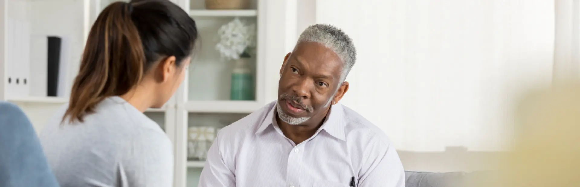 Prostate cancer patient in discussion with social worker about navigating treatment and support services