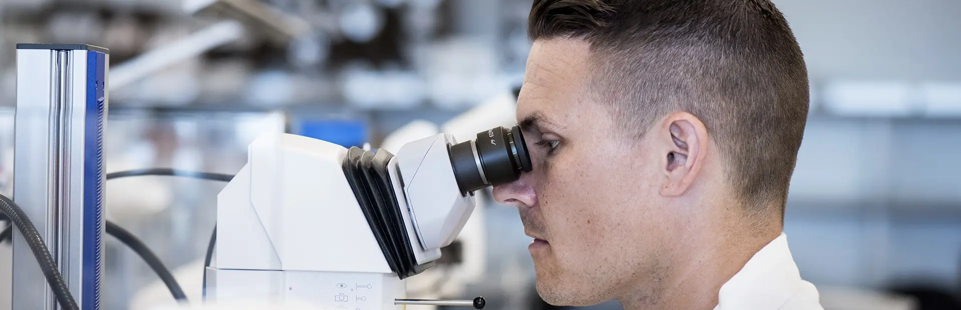 Man looking into a microscope