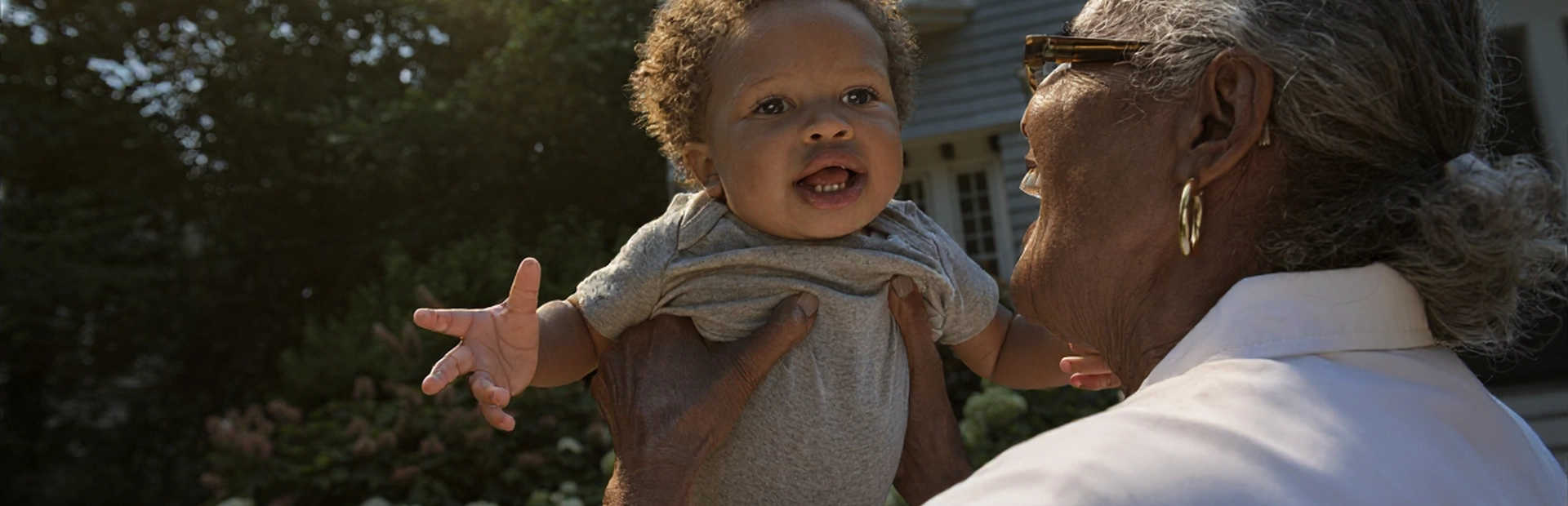 Grandparent and toddler sharing a joyful moment outside
