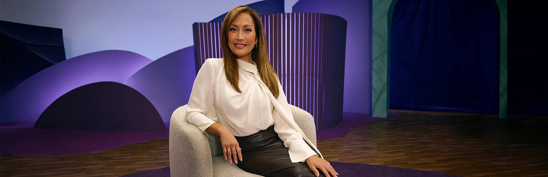 Carrie Ann Inaba smiling on set of SJÖUT for Sjögren's disease education campaign.
