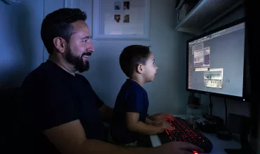 Father and son infront of a computer