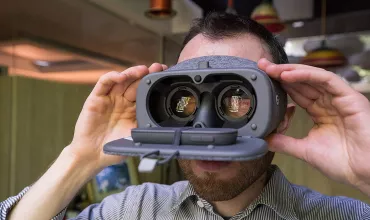 Close up of a man looking into virtual reality glasses