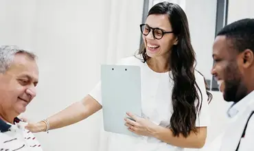smiling patient and two healthcare professionals