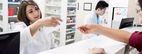 pharmacist reading customer prescription image_0