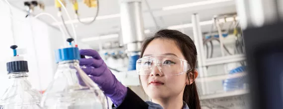 Scientist working in lab with purple gloves