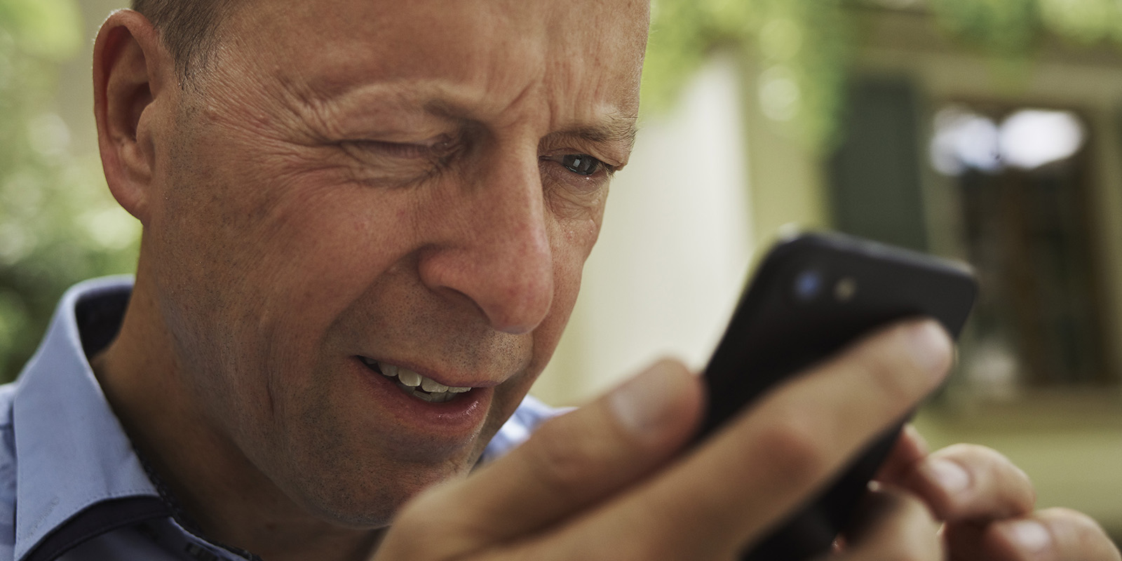 Mature man looking at mobile phone