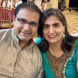 Tina and Anand smiling for a photograph