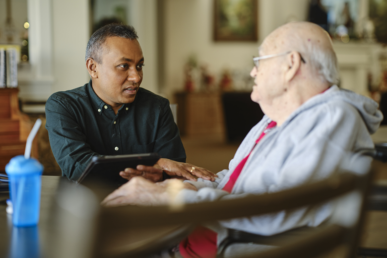 Male patient discussing treatment options with healthcare provider during oncology consultation