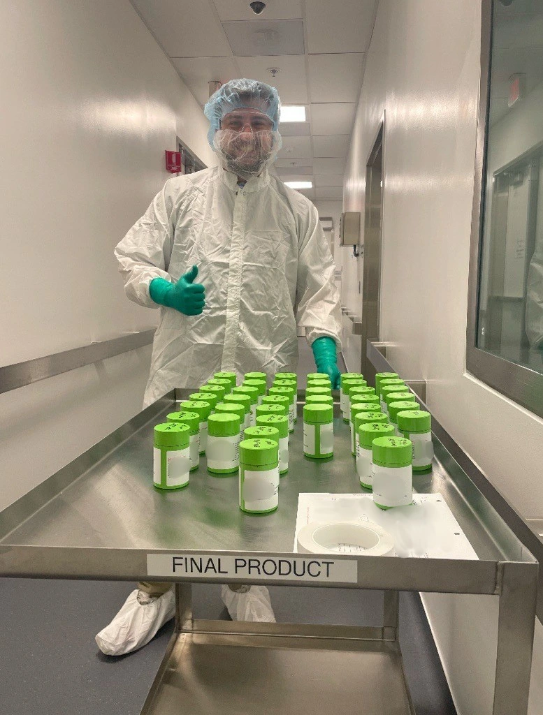 Carter Jaynes, RLT Production Manager at Novartis, with a batch of RLT doses.