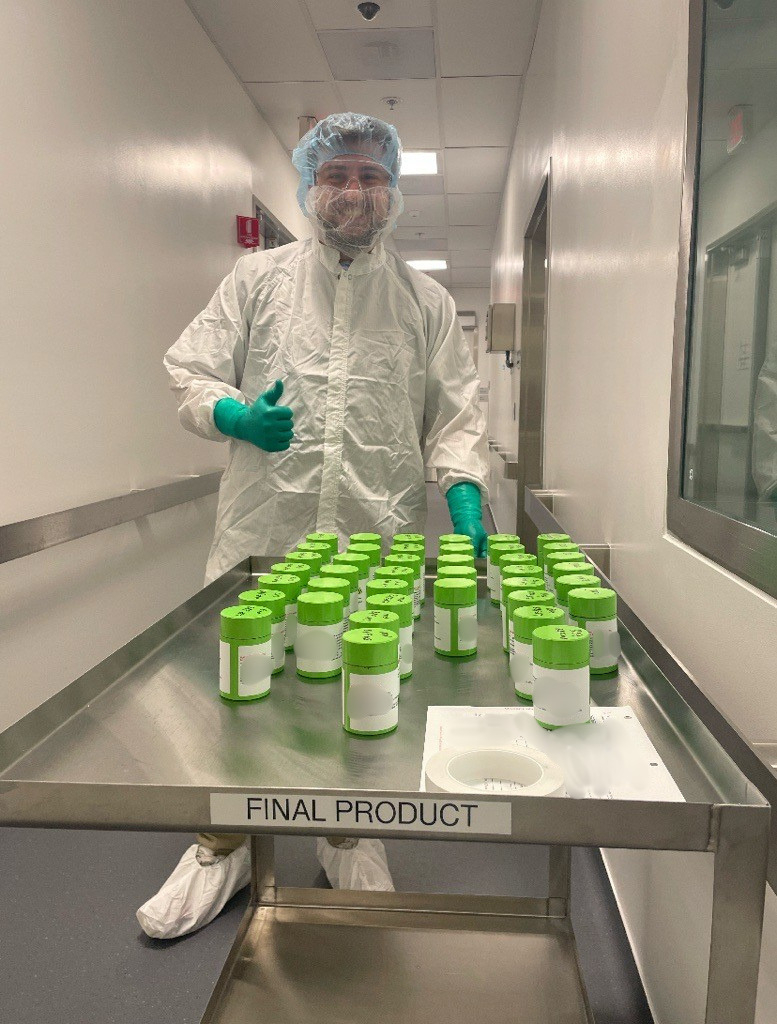 Carter Jaynes, RLT Production Manager at Novartis, with a batch of RLT doses.