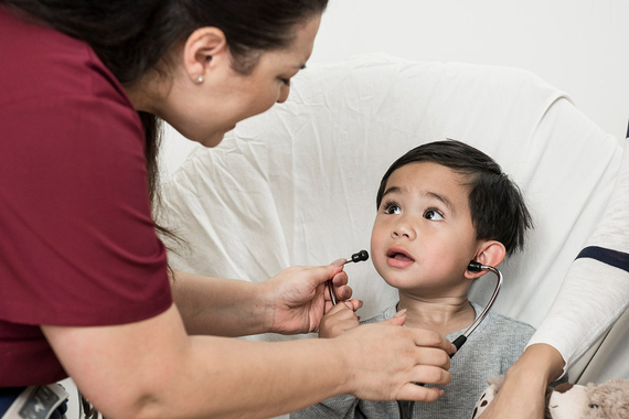 Young boy wearing stethoscope