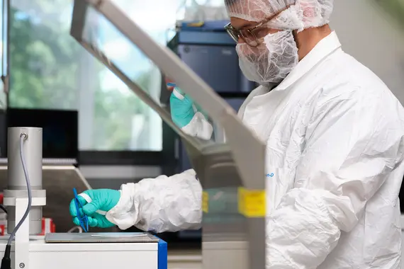 Scientist in protective gear working in a laboratory