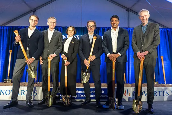 Novartis team on stage at an event smiling together