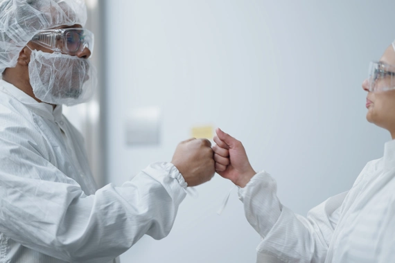 scientists fist bumping 