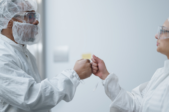 scientists fist bumping 