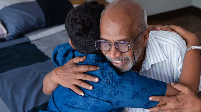 Grandfather hugging his grandson