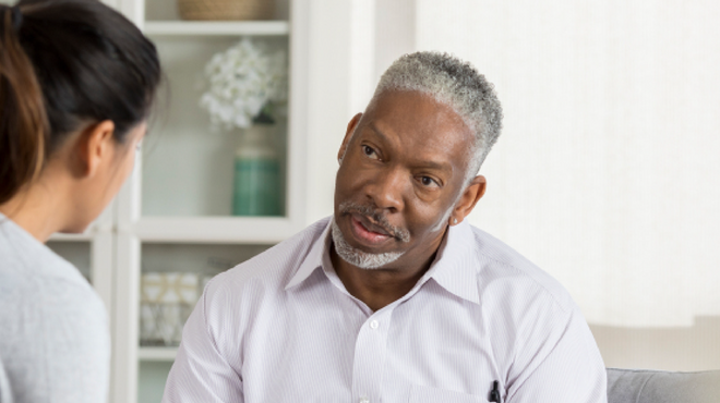 Prostate cancer patient in discussion with social worker about navigating treatment and support services