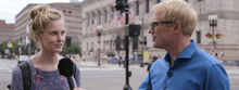 Novartis scientist talks to woman on the street.
