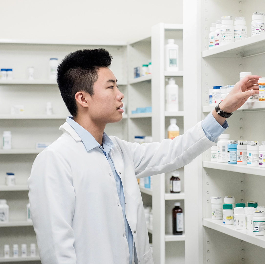 Pharmacist reaching for prescription 