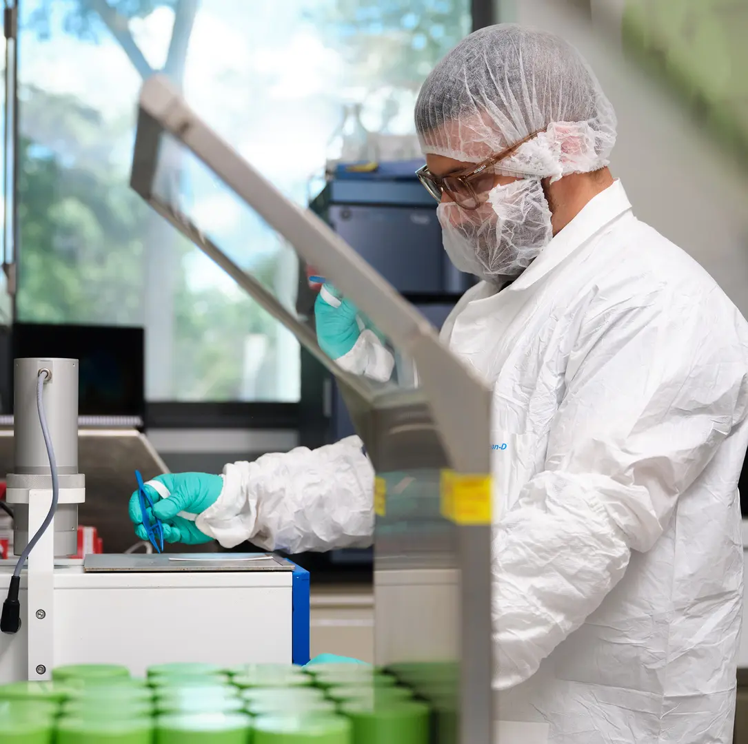 Scientist in protective gear working in a laboratory